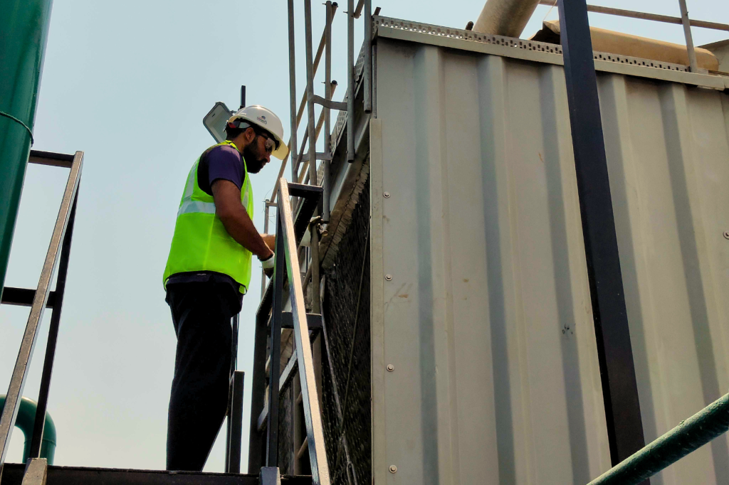 Energeia engineer in the field in Hyderabad working on the cooling tower of the HVAC system